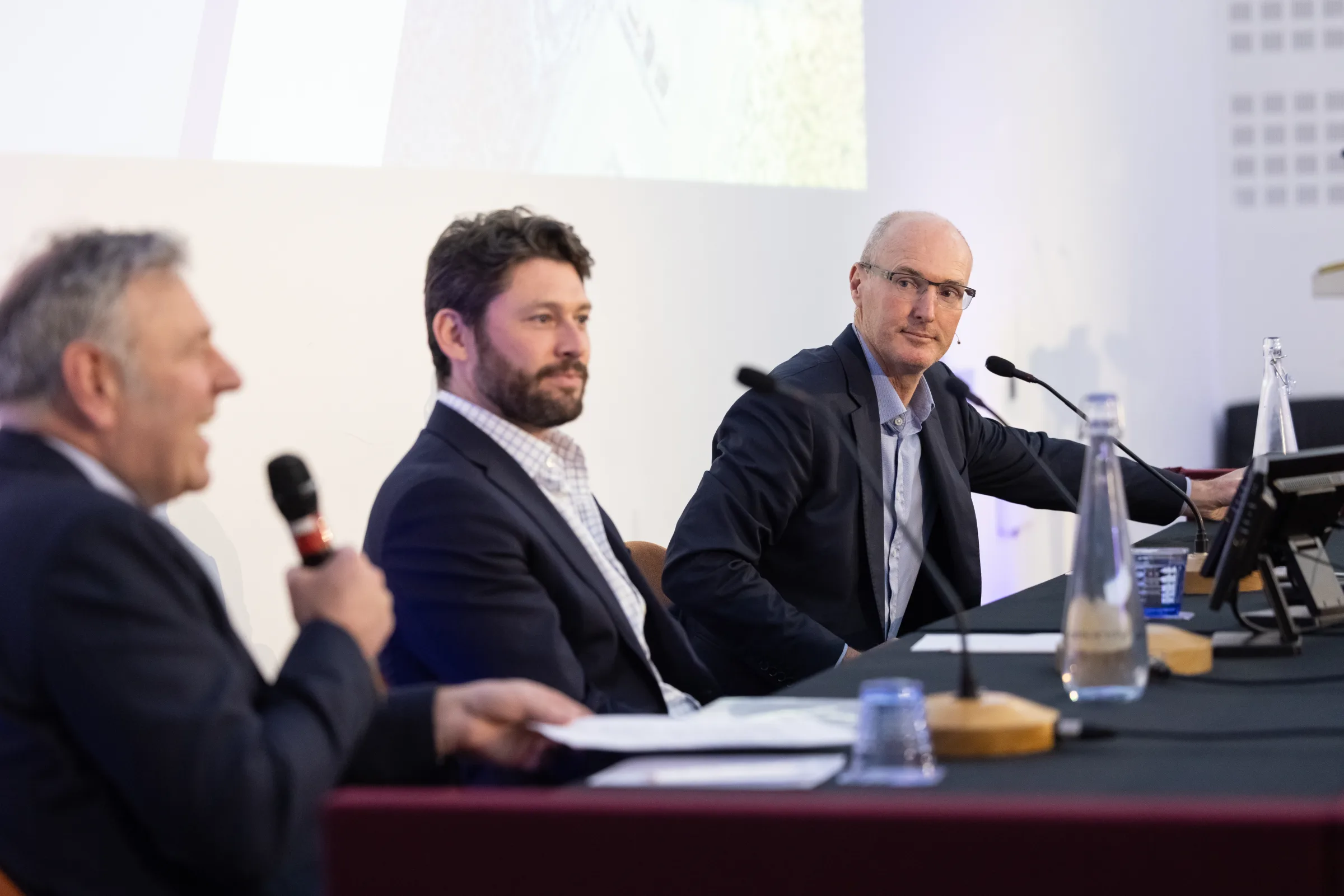 Greatland Resources town hall panel — host with microphone leading the conversation on stage