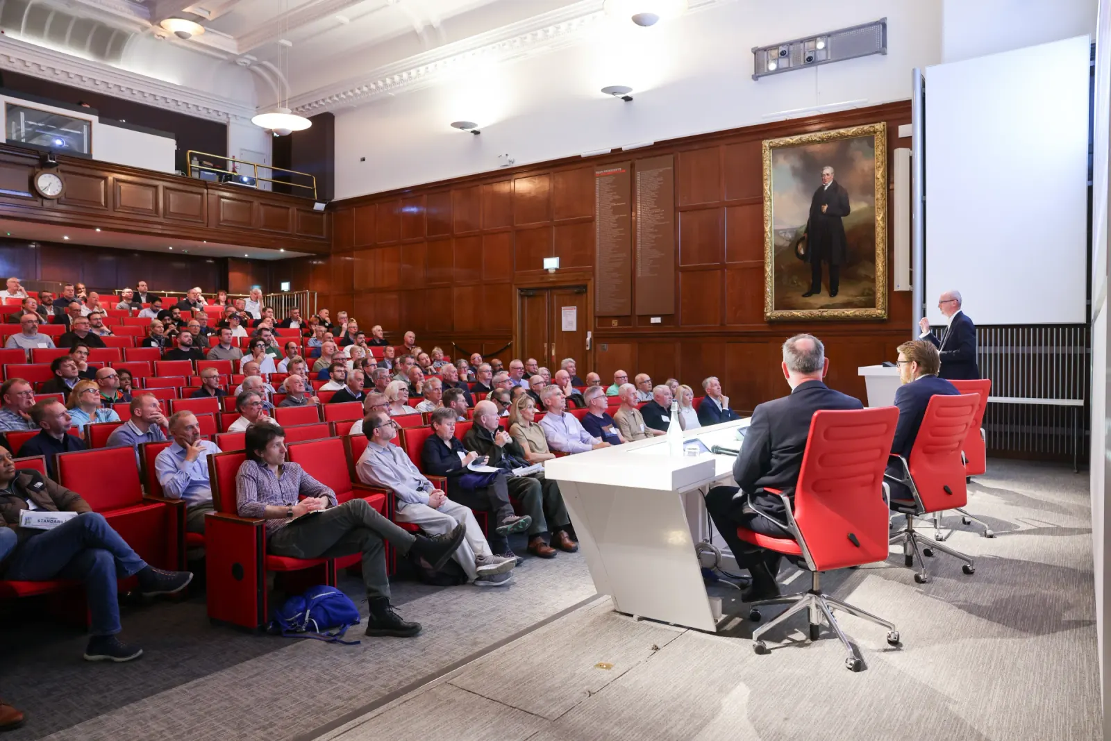 Wide view of the Greatland Resources town hall — full audience and panel